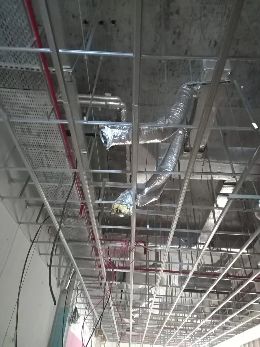 Flexible and rigid ductwork installed above a suspended ceiling grid