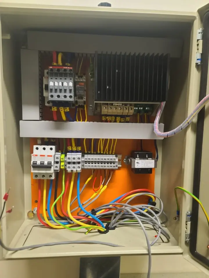 Inside of the heater control panel showing contactors, breakers and wiring