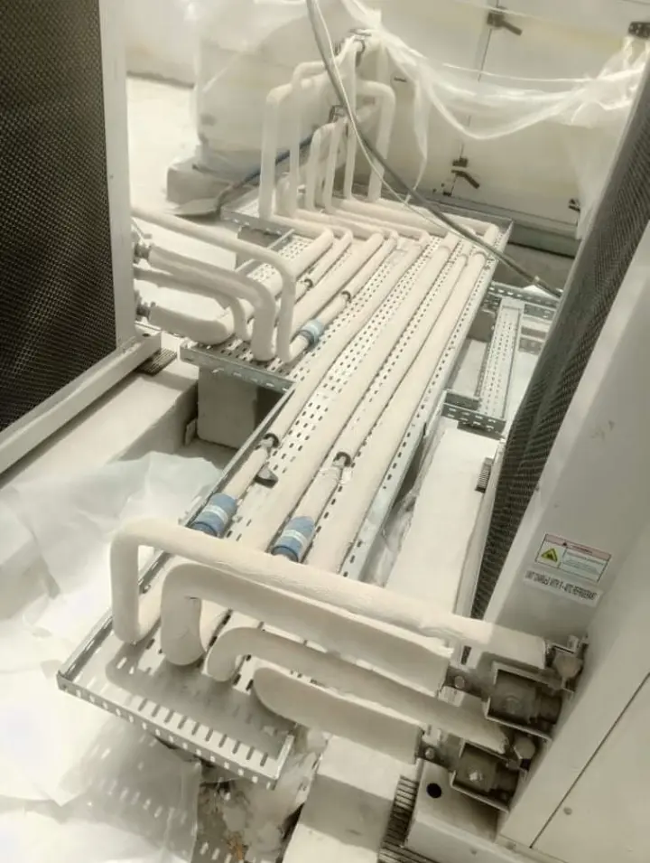 Insulated refrigerant piping laid on cable trays