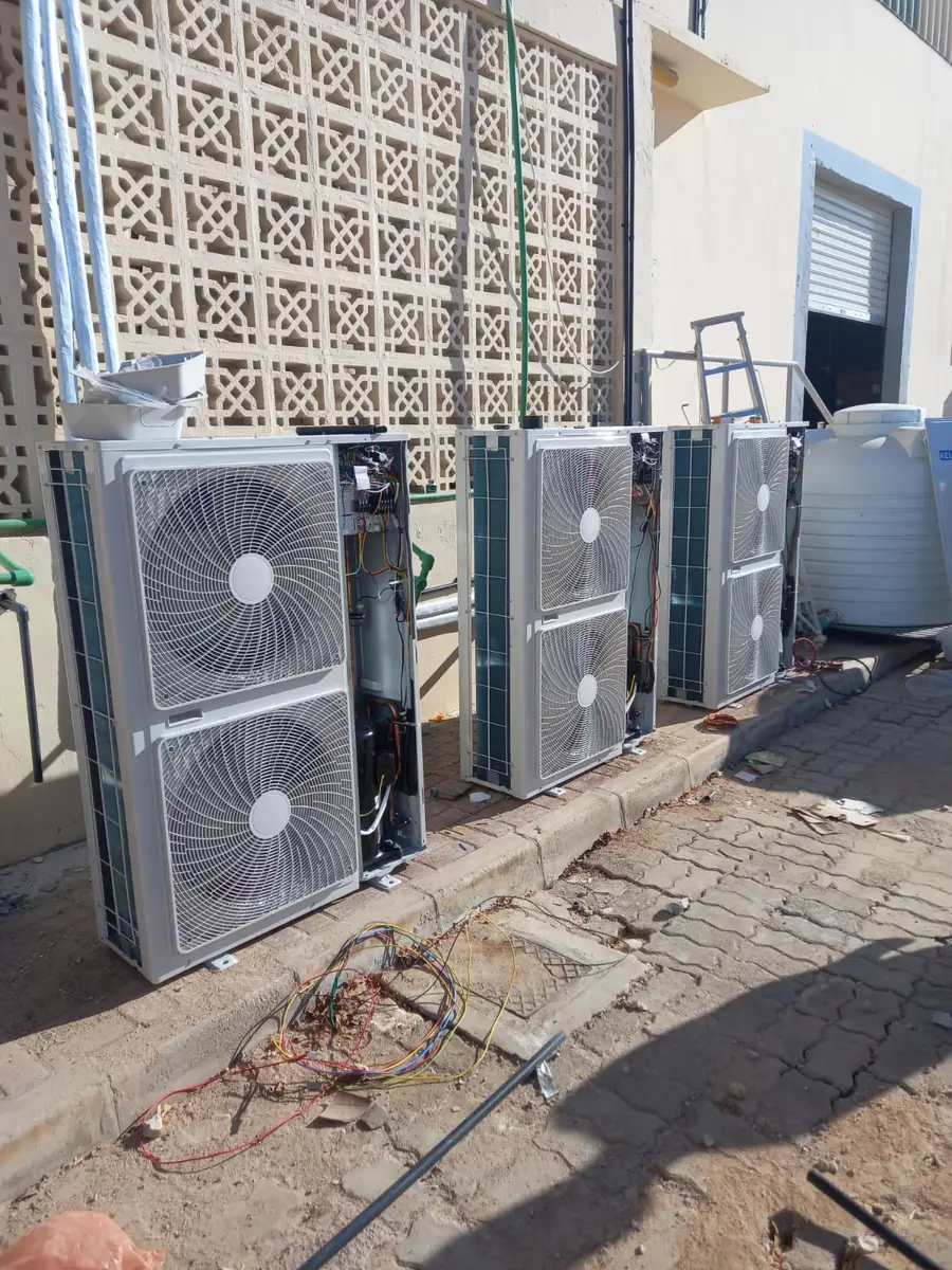 Several split AC outdoor units mounted along a wall