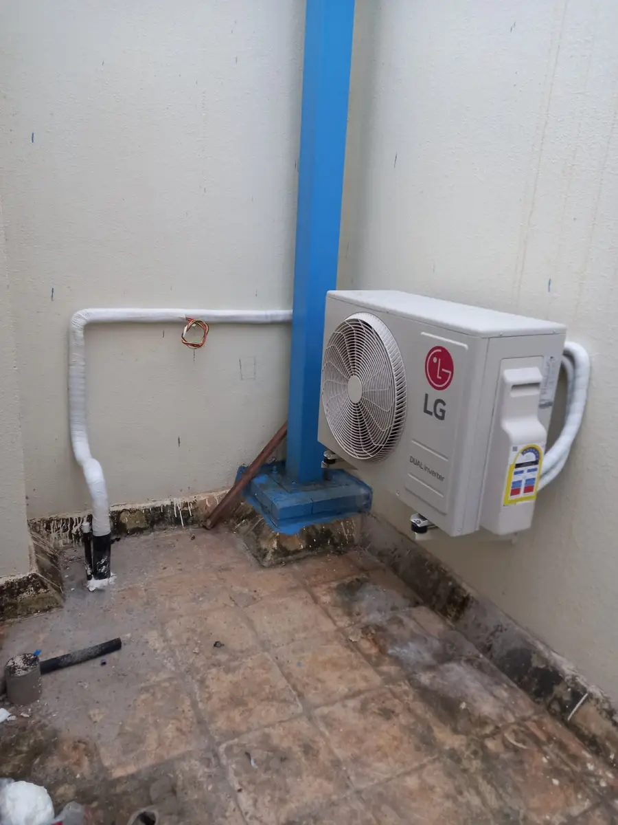 Wall-mounted split AC outdoor unit with neatly run piping